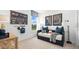 Cozy bedroom with baseball decor, a comfortable daybed, and ample natural light for a relaxing space at 3404 Lumber Falls Dr, Plant City, FL 33565