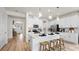 Bright, white kitchen with large island, pendant lighting, and stainless appliances offers a modern, open space at 3404 Lumber Falls Dr, Plant City, FL 33565