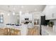 Bright modern kitchen with white cabinetry, stainless steel appliances, pendant lighting and wood flooring at 3404 Lumber Falls Dr, Plant City, FL 33565