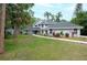 Charming two-story home with landscaped yard, lush green lawn and inviting walkway at 35 Deerpath Dr, Oldsmar, FL 34677