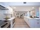 Open-concept kitchen with quartz countertops flows into the living room with fireplace and pool views at 35 Deerpath Dr, Oldsmar, FL 34677