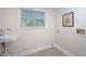 Clean laundry room featuring a sink, window and modern flooring, ready for your appliances at 35 Deerpath Dr, Oldsmar, FL 34677