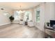 Inviting living room with large windows, modern light fixture, and stylish decor at 35 Deerpath Dr, Oldsmar, FL 34677