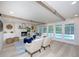 Spacious living room with fireplace, wood beams and access to a pool via french doors at 35 Deerpath Dr, Oldsmar, FL 34677