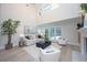 Bright living room features a fireplace, high ceilings, and access to the backyard pool area at 35 Deerpath Dr, Oldsmar, FL 34677