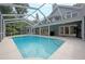 Backyard swimming pool with screened-in enclosure at 35 Deerpath Dr, Oldsmar, FL 34677