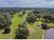 Lush green golf course and surrounding landscape with mature trees and water features viewed from above at 36901 Tara Ave, Zephyrhills, FL 33542