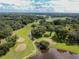 Beautiful aerial view of the golf course with ponds, mature trees and lush landscaping at 36901 Tara Ave, Zephyrhills, FL 33542