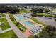Aerial view of a community pool, featuring ample seating, shade, and a serene lakeside backdrop at 36901 Tara Ave, Zephyrhills, FL 33542