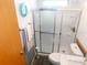 Clean bathroom featuring a walk-in shower with a sliding door, toilet, and white sink vanity at 36901 Tara Ave, Zephyrhills, FL 33542