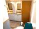 This bathroom has double sinks, granite countertops, and wood look flooring at 36901 Tara Ave, Zephyrhills, FL 33542