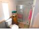 This bathroom features a toilet, shower, and storage shelf at 36901 Tara Ave, Zephyrhills, FL 33542