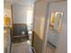 This bathroom has white cabinetry, granite countertops, and wood look flooring at 36901 Tara Ave, Zephyrhills, FL 33542