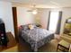 Bedroom features a ceiling fan, large window and dresser at 36901 Tara Ave, Zephyrhills, FL 33542