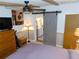 This bedroom has an ensuite bath and a sliding barn door at 36901 Tara Ave, Zephyrhills, FL 33542