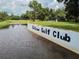 Signage along the water feature identifies the property as the 'Betmar Golf Club' at 36901 Tara Ave, Zephyrhills, FL 33542