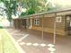 Wide covered parking featuring a checkered pattern design, with convenient home access at 36901 Tara Ave, Zephyrhills, FL 33542