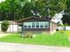 Charming home featuring a well-manicured lawn, covered parking, and lovely stone accents at 36901 Tara Ave, Zephyrhills, FL 33542