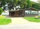 Inviting exterior with covered parking, charming stone accents, and a well-maintained lawn at 36901 Tara Ave, Zephyrhills, FL 33542