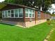 View of home with tidy landscaping, stone accents, and neutral siding at 36901 Tara Ave, Zephyrhills, FL 33542
