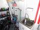 Garage containing a utility sink with accessories stored around it at 36901 Tara Ave, Zephyrhills, FL 33542