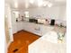 Charming kitchen with white cabinetry, granite countertops, and stainless steel appliances at 36901 Tara Ave, Zephyrhills, FL 33542