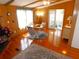 Living room with wood floors, a dining area, and access to a sunroom at 36901 Tara Ave, Zephyrhills, FL 33542