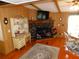 Living room with wood paneling, stone fireplace, and decorative accents at 36901 Tara Ave, Zephyrhills, FL 33542