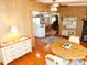 Open concept living room with wood floors and view into the kitchen at 36901 Tara Ave, Zephyrhills, FL 33542