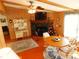 Living room with wood paneling, a stone fireplace, and a ceiling fan at 36901 Tara Ave, Zephyrhills, FL 33542