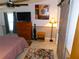 Bedroom with ceiling fan, dresser, TV and wood-look floors at 36901 Tara Ave, Zephyrhills, FL 33542