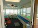 Bright sunroom with multiple windows, comfortable seating, and a ceiling fan at 36901 Tara Ave, Zephyrhills, FL 33542