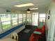 Bright sunroom with large windows, a seating area, and a ceiling fan at 36901 Tara Ave, Zephyrhills, FL 33542