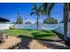 Lush green backyard featuring a hammock and white vinyl fence, offering a serene and private outdoor space at 4191 Maple Ne St, St Petersburg, FL 33703