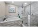 Modern bathroom with tiled shower, bathtub, and sleek fixtures at 4191 Maple Ne St, St Petersburg, FL 33703