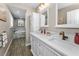 Bathroom with double sinks, white cabinets and neutral paint at 4191 Maple Ne St, St Petersburg, FL 33703