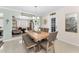 Elegant dining room featuring a wooden table with seating for six, complemented by a chandelier and neutral decor at 4191 Maple Ne St, St Petersburg, FL 33703