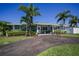 Inviting home with a well-manicured lawn, mature landscaping, and a circular driveway leading to the front entrance at 4191 Maple Ne St, St Petersburg, FL 33703
