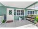Cozy front porch with a swing, decorative plants, and a welcoming entrance, creating an inviting curb appeal at 4191 Maple Ne St, St Petersburg, FL 33703