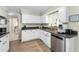 Bright kitchen features white cabinets, stainless steel appliances, and wood-look flooring at 4191 Maple Ne St, St Petersburg, FL 33703