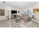 Cozy living room with modern entertainment center, neutral-toned sofas, and a stylish glass coffee table on a decorative rug at 4191 Maple Ne St, St Petersburg, FL 33703