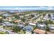 Expansive aerial view of waterfront neighborhood with canals, marina, and single Gathering homes under a sunny, blue sky at 4710 Travertine Dr, Tampa, FL 33615