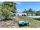 Spacious backyard with a pool, lounge chairs, and a cornhole game at 4710 Travertine Dr, Tampa, FL 33615