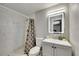 The bathroom offers a marble shower, illuminated mirror, and modern fixtures at 4710 Travertine Dr, Tampa, FL 33615