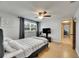 This bedroom features a ceiling fan, television, and natural light at 4710 Travertine Dr, Tampa, FL 33615