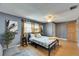Bright bedroom features hardwood floors, a cozy bed, and natural light from the windows at 4710 Travertine Dr, Tampa, FL 33615