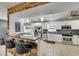 Modern kitchen with white cabinetry, stainless steel appliances, a breakfast bar, and neutral countertops at 4710 Travertine Dr, Tampa, FL 33615