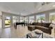 Bright living room with many windows, tile floors and comfortable seating at 4710 Travertine Dr, Tampa, FL 33615