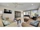 Spacious living room with tile flooring, comfortable seating, and a game room view at 4710 Travertine Dr, Tampa, FL 33615