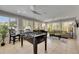 Sunlit living area featuring a foosball table and an airy atmosphere at 4710 Travertine Dr, Tampa, FL 33615